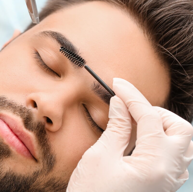 Man getting eyebrow shaping treatment