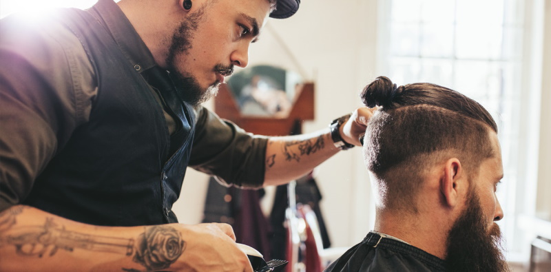 hairdresser cutting man's hair